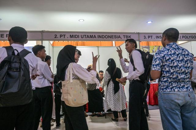 Physically challenged candidates wait to submit their application forms during a job fair organised by the government for people with disabilities in Surabaya, East Java province on November 25, 2025. (Photo by JUNI KRISWANTO / AFP)