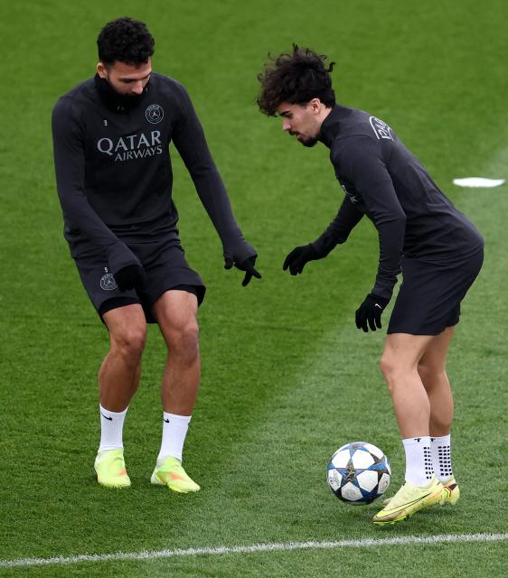 Paris Saint-Germain's Portuguese forward #9 Goncalo Ramos (L) fights for the ball with Paris Saint-Germain's Portuguese midfielder #17 Vitinha (R) attend during a training session at the Campus Paris Saint-Germain in Poissy, in the western outskirts of Paris, on November 25, 2025, on the eve of the UEFA Champions League first round day 5 football match between Paris Saint-Germain and Tottenham Hotspur. (Photo by FRANCK FIFE / AFP)