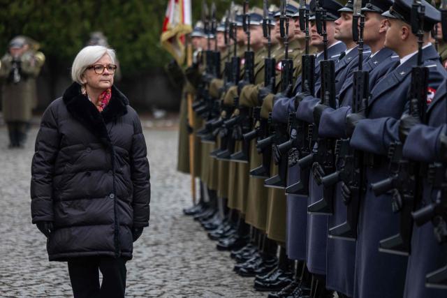French Minister of the Armed Forces Catherine Vautrin (L) and Poland's Minister of Defence (not in picture) review an honor guard during an official welcoming ceremony in front of the ministry building in Warsaw, Poland, on November 25, 2025. (Photo by Wojtek RADWANSKI / AFP)