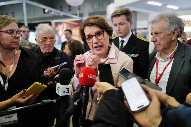 France's Agriculture Minister Annie Genevard (C) speaks to the press during her visit to the SITEVI salon at the Montpellier Parc Expo exhibition in Pérols, near Montpellier, southtern France, on November 25, 2025. (Photo by Sylvain THOMAS / AFP)
