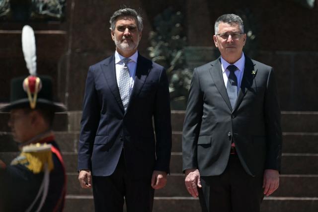 Israel's Foreign Minister Gideon Sa'ar (R) and Argentina's Secretary of International Economic Relations Fernando Brun take part in a wreath-laying ceremony in homage to Argentine national hero General Jose de San Martin in Buenos Aires on November 25, 2025. Sa'ar is in Argentina on official visit. (Photo by JUAN MABROMATA / AFP)