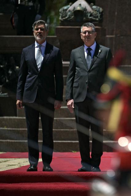 Israel's Foreign Minister Gideon Sa'ar (R) and Argentina's Secretary of International Economic Relations Fernando Brun take part in a wreath-laying ceremony in homage to Argentine national hero General Jose de San Martin in Buenos Aires on November 25, 2025. Sa'ar is in Argentina on official visit. (Photo by JUAN MABROMATA / AFP)