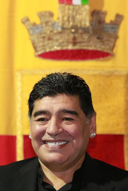 (FILES) Former Argentinian football player Diego Armando Maradona smiles as he receives the honorary citizenship of Naples from city's mayor during a ceremony at the cityhall on July 5, 2017, in Naples, Italy. On November 25, 2025, Argentina remembers Diego Maradona five years after his death, and the star's family demands justice for his alleged murder, for which his medical team will stand trial in 2026. Dozens of clubs and players remembered the Argentine idol, who died at the age of 60, while recovering from neurosurgery at his home in Buenos Aires, with emotional messages and videos. (Photo by CARLO HERMANN / AFP)