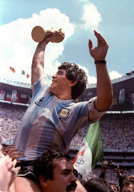 (FILES) (FILES) Diego Maradona raises the World Cup trophy after Argentina won the 1986 Mexico City World Cup in this June 1986 file photo.  Maradona has been hospitalized 18 April 2004 in a private clinic in Buenos Aires. According to a TV channel and Maradona's close circle he is in a critical condition due to a drug overdose.  AFP PHOTO. On November 25, 2025, Argentina remembers Diego Maradona five years after his death, and the star's family demands justice for his alleged murder, for which his medical team will stand trial in 2026. Dozens of clubs and players remembered the Argentine idol, who died at the age of 60, while recovering from neurosurgery at his home in Buenos Aires, with emotional messages and videos. (Photo by AFP)