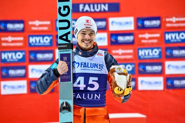 Third placed Germany's Philipp Raimund celebrates on the podium of the Men's Individual HS95 competition of the ski jumping World Cup, in Falun, Sweden, on November 25, 2025. (Photo by Fredrik SANDBERG / TT NEWS AGENCY / AFP) / Sweden OUT