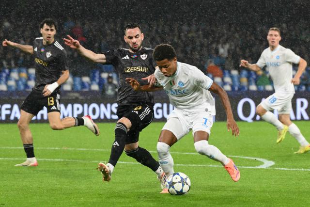 Napoli's Brazilian forward #07 David Neres fights for the ball with Garabagh's Montenegrin midfielder #08 Marko Jankovic during the UEFA Champions League - league phase day 5 football match between Napoli and Qarabag at the Diego Armando Maradona stadium in Naples on November 25, 2025. (Photo by Alberto PIZZOLI / AFP)