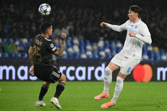 Napoli's Scottish midfielder #08 Scott McTominay fights for the ball with Garabagh's Brazilian midfielder #35 Pedro Bicalho during the UEFA Champions League - league phase day 5 football match between Napoli and Qarabag at the Diego Armando Maradona stadium in Naples on November 25, 2025. (Photo by Alberto PIZZOLI / AFP)