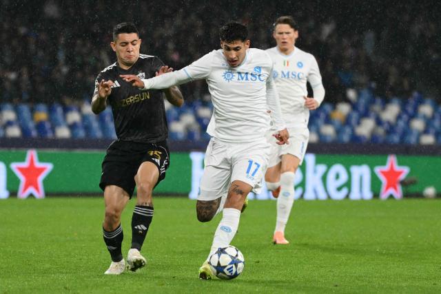 Napoli's Uruguayan defender #17 Mathias Olivera fights for the ball with Garabagh's Brazilian midfielder #35 Pedro Bicalho during the UEFA Champions League - league phase day 5 football match between Napoli and Qarabag at the Diego Armando Maradona stadium in Naples on November 25, 2025. (Photo by Alberto PIZZOLI / AFP)
