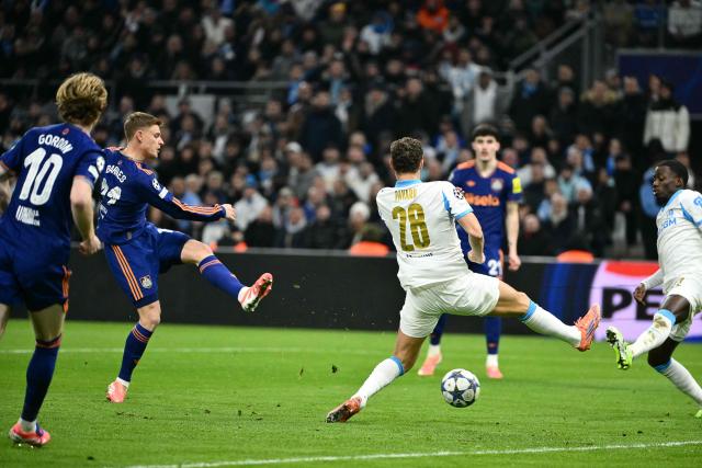 Newcastle United's English midfielder #11 Harvey Barnes (L) shoots and scores the opening goal during the UEFA Champions League, league phase - matchday 5, football match between Olympique de Marseille (OM) and Newcastle United FC at the Velodrome Stadium in Marseille, southeastern France, on November 25, 2025. (Photo by Christophe SIMON / AFP)
