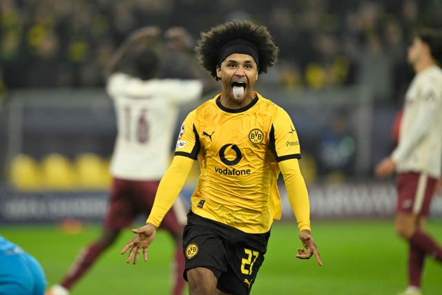 Dortmund's German forward #27 Karim Adeyemi (C) celebrates after scoring the 3-0 goal as Villarreal's Ghanaian midfielder #16 Thomas Partey (L, background) reacts during the UEFA Champions League league phase day 5 football match between Borussia Dortmund and Villareal CF in Dortmund, on November 25, 2025. (Photo by INA FASSBENDER / AFP)