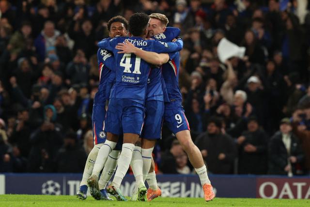 Chelsea's English striker #09 Liam Delap (R) celebrates with teammates after scoring their third goal during the UEFA Champions League league-phase football match between Chelsea and Barcelona at Stamford Bridge in London on November 25, 2025. (Photo by Adrian Dennis / AFP)
