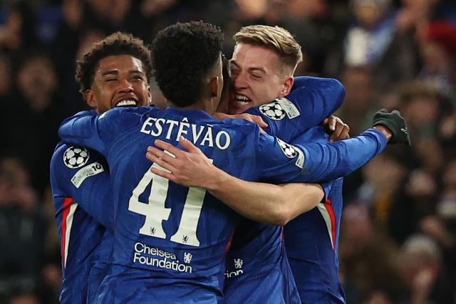 Chelsea's English striker #09 Liam Delap (R) celebrates with teammates after scoring their third goal during the UEFA Champions League league-phase football match between Chelsea and Barcelona at Stamford Bridge in London on November 25, 2025. (Photo by Adrian Dennis / AFP)