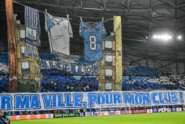 Marseille supporters display a giant tifo and a banner reading "For my city, for my club" prior to the UEFA Champions League, league phase - matchday 5, football match between Olympique de Marseille (OM) and Newcastle United FC at the Velodrome Stadium in Marseille, southeastern France, on November 25, 2025. (Photo by Christophe Simon / AFP)