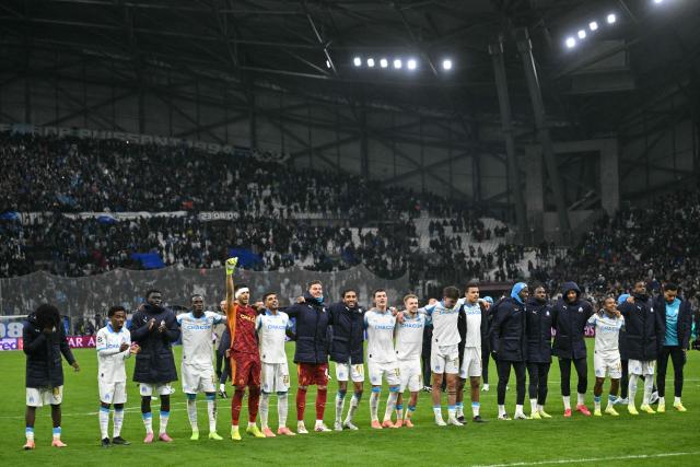 Marseille's players celebrate after winning the UEFA Champions League, league phase - matchday 5, football match between Olympique de Marseille (OM) and Newcastle United FC at the Velodrome Stadium in Marseille, southeastern France, on November 25, 2025. (Photo by Christophe Simon / AFP)