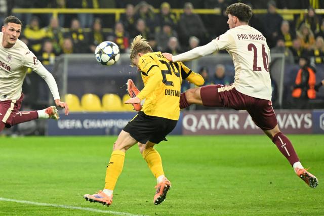 Dortmund's Swedish defender #24 Daniel Svensson (C) hits the ball to score the 4-0 goal during the UEFA Champions League league phase day 5 football match between Borussia Dortmund and Villareal CF in Dortmund, on November 25, 2025. (Photo by INA FASSBENDER / AFP)