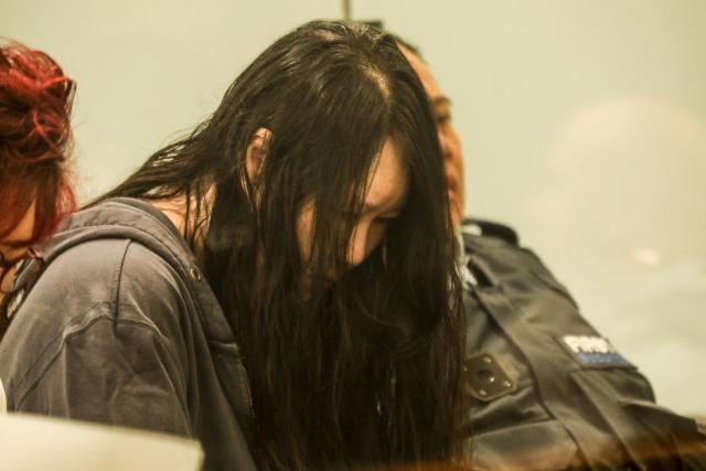 Hakyung Lee looks down during her sentencing to life imprisonment for the murder of her two children, whose bodies were found stuffed into suitcases in a storage locker, at Auckland High Court, Auckland, New Zealand, November 26, 2025. Hakyung Lee, a New Zealand citizen originally from South Korea, was earlier this year found guilty of killing her children in a grisly crime dubbed the country's "suitcase murders". (Photo by Markia KHABAZI / POOL / AFP)