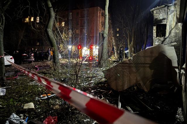 Law enforcement officers work in the courtyard of a damaged residential building following an air attack in Zaporizhzhia on November 25, 2025, amid the Russian invasion of Ukraine. (Photo by Darya NAZAROVA / AFP)