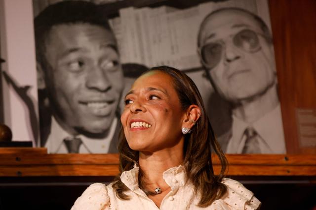 Flavia Arantes do Nascimento, daughter of late Brazilian football legend Pele, gestures during the announcement of the acquisition of her father's brand by NR Sports, at the Pele Museum, in Santos, Sao Paulo, Brazil on November 25, 2025. (Photo by Miguel Schincariol / AFP)
