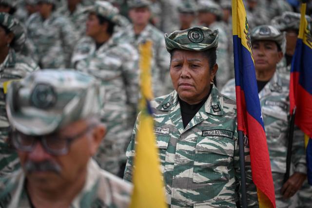 Members of the Bolivarian National Militia attend a military ceremony at Fuerte Tiuna in Caracas on November 25, 2025. (Photo by Federico PARRA / AFP)