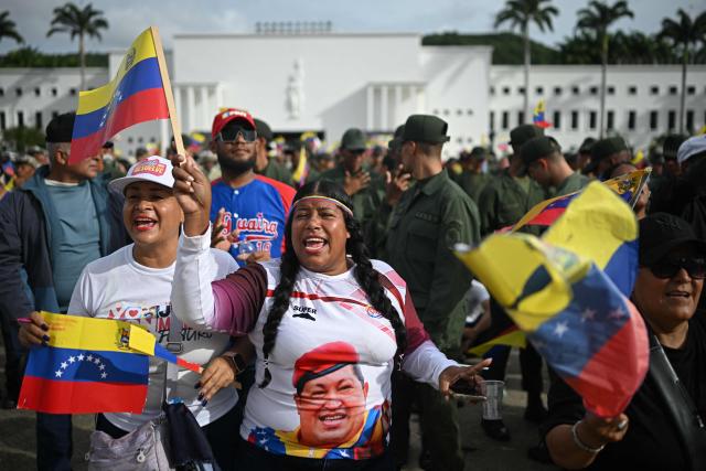 Supporters of Venezuela's President Nicolas Maduro attend a military ceremony at Fuerte Tiuna, in Caracas on November 25, 2025. (Photo by Federico PARRA / AFP)