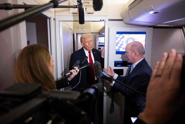 US President Donald Trump speaks to journalists aboard Air Force One travelling from Joint Base Andrews to Palm Beach International Airport on November 25, 2025. President Donald Trump and First Lady Melania Trump are traveling to Mar-a-Lago for the Thanksgiving holiday. (Photo by Jim WATSON / AFP)