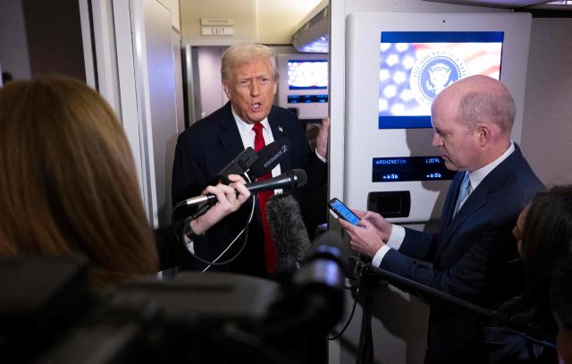 US President Donald Trump speaks to journalists aboard Air Force One travelling from Joint Base Andrews to Palm Beach International Airport on November 25, 2025. President Donald Trump and First Lady Melania Trump are traveling to Mar-a-Lago for the Thanksgiving holiday. (Photo by Jim WATSON / AFP)