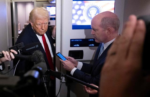 US President Donald Trump speaks to journalists aboard Air Force One travelling from Joint Base Andrews to Palm Beach International Airport on November 25, 2025. President Donald Trump and First Lady Melania Trump are traveling to Mar-a-Lago for the Thanksgiving holiday. (Photo by Jim WATSON / AFP)