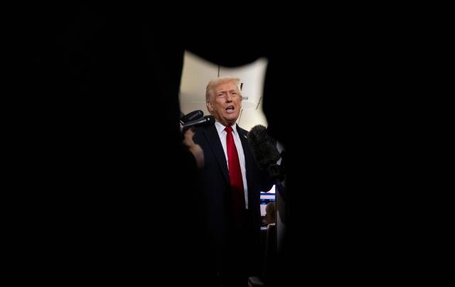 US President Donald Trump speaks to journalists aboard Air Force One travelling from Joint Base Andrews to Palm Beach International Airport on November 25, 2025. President Donald Trump and First Lady Melania Trump are traveling to Mar-a-Lago for the Thanksgiving holiday. (Photo by Jim WATSON / AFP)
