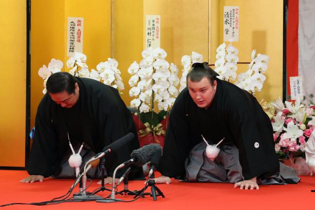 Ukrainian sumo wrestler Danylo Yavhusishyn (R), who is known by his ring name Aonishiki, gives a speech at the ceremony announcing his promotion to ozeki in Kurume City, Fukuoka Prefecture on November 26, 2025, accompanied by his stable master Ajigawa (L). (Photo by JIJI Press / AFP) / Japan OUT