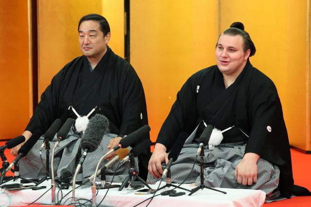 Ukrainian sumo wrestler Danylo Yavhusishyn (R), who is known by his ring name Aonishiki, attends a press conference with his stable master Ajigawa (L) after the ceremony announcing his promotion to ozeki in Kurume City, Fukuoka Prefecture on November 26, 2025. (Photo by JIJI Press / AFP) / Japan OUT