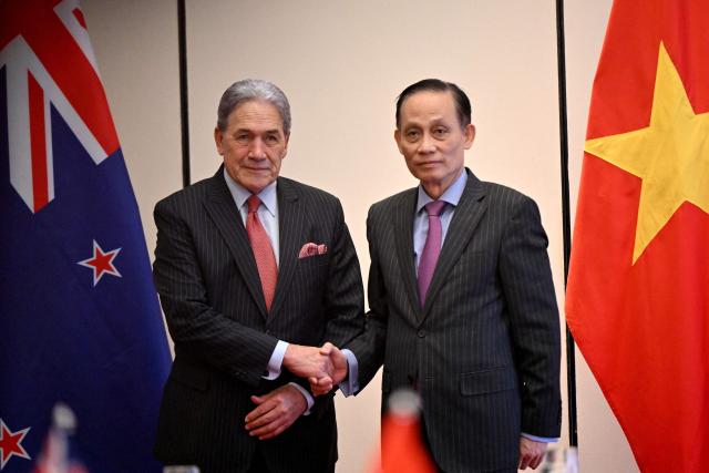 New Zealand's Foreign Minister Winston Peters (L) shakes hands with Vietnam's Foreign Minister Le Hoai Trung during a meeting in Hanoi on November 26, 2025. (Photo by Nhac NGUYEN / AFP)