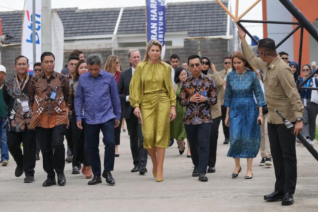Queen Maxima of the Netherlands (C), in her capacity as the UN Secretary General's Special Advocate for Financial Health (UNSGSA), visits a subsidised housing complex for low-income families in Bekasi, West Java, on November 26, 2025. (Photo by Tatan Syuflana / POOL / AFP)