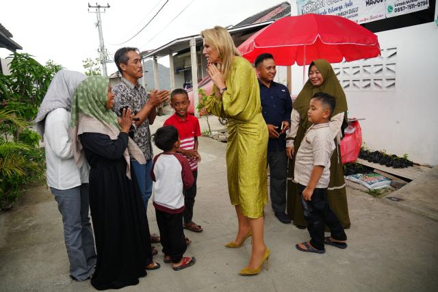 Queen Maxima of the Netherlands (C), in her capacity as the UN Secretary General's Special Advocate for Financial Health (UNSGSA), talks to residents during a visit to a subsidised housing complex for low-income families in Bekasi, West Java, on November 26, 2025. (Photo by Tatan Syuflana / POOL / AFP)