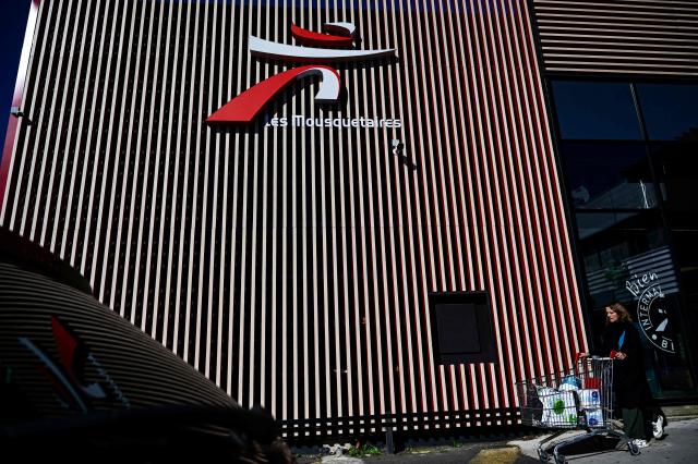 (FILES) This photograph shows the logo of French supermarket Intermarche of the group 'Les Mousquetaires' on the facade of a company store in Beziers, southern France, on March 30, 2025. After several years of difficulties, French retailer Auchan announced on on November 25, 2025 that it plans to operate all of its approximately 300 French supermarkets (excluding Corsica) as franchises under the Intermarche and Netto banners. (Photo by GABRIEL BOUYS / AFP)