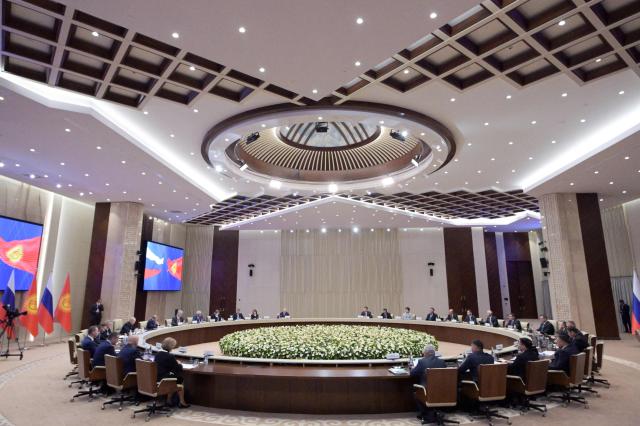 In this pool photograph distributed by the Russian state agency Sputnik, Russia's President Vladimir Putin and Kyrgyz President Sadyr Japarov hold talks at the Yntymak Ordo (Palace of Unity) presidential residence in Bishkek on November 26, 2025. (Photo by Alexey NIKOLSKY / POOL / AFP)
