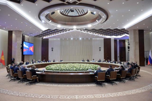 In this pool photograph distributed by the Russian state agency Sputnik, Russia's President Vladimir Putin and Kyrgyz President Sadyr Japarov hold talks at the Yntymak Ordo (Palace of Unity) presidential residence in Bishkek on November 26, 2025. (Photo by Alexey NIKOLSKY / POOL / AFP)