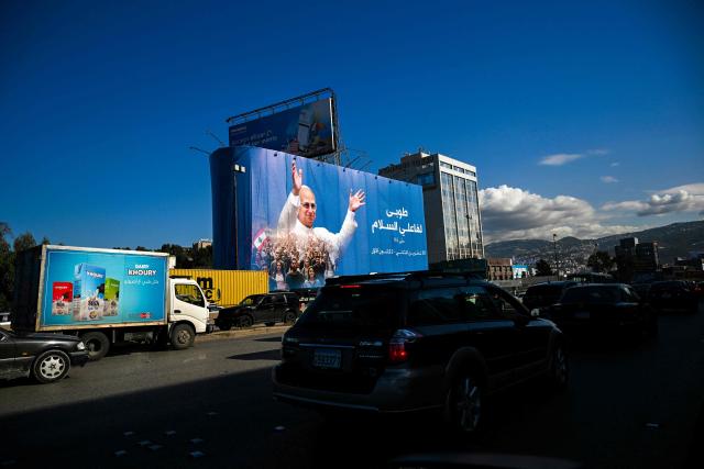 EDITORS NOTE: Graphic content / Motorists drive past a billboard displaying a picture of Pope Leo XIV in Beirut on November 25, 2025. In his first trip abroad since becoming head of the Catholic Church, US-born Pope Leo XIV will travel to Turkey and Lebanon, arriving in Beirut on November 30. (Photo by Joseph EID / AFP)