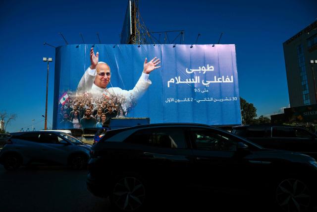EDITORS NOTE: Graphic content / Motorists drive past a billboard displaying a picture of Pope Leo XIV in Beirut on November 25, 2025. In his first trip abroad since becoming head of the Catholic Church, US-born Pope Leo XIV will travel to Turkey and Lebanon, arriving in Beirut on November 30. (Photo by Joseph EID / AFP)