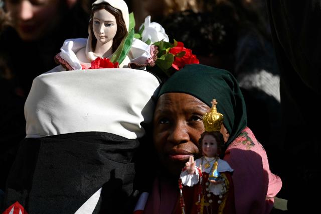 A woman attends Pope Leo XIV weekly general audience in St Peter's square in The Vatican on November 26, 2025. (Photo by Filippo MONTEFORTE / AFP)