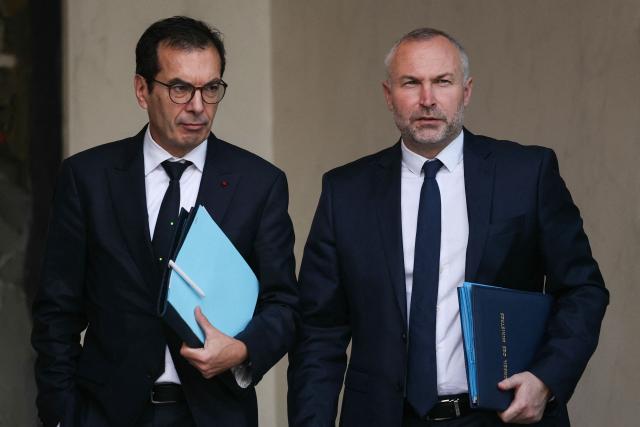 France's Labour Minister Jean-Pierre Farandou (L) and France's junior Minister in charge of parliament relations Laurent Panifous leave the Elysee Palace, in Paris after the weekly cabinet meeting, on November 26, 2025. (Photo by Thomas SAMSON / AFP)