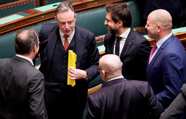 Belgium's Prime Minister Bart De Wever (2nd L) reacts after a plenary session at Belgium's federal parliament, in Brussels on November 26, 2025. (Photo by BENOIT DOPPAGNE / Belga / AFP) / Belgium OUT