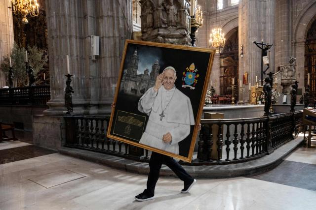 AFP PICTURES OF THE YEAR 2025

A church worker carries a portrait of the late Pope Francis during a memorial mass at the main cathedral at the El Zocalo Square in Mexico City on April 21, 2025.. Pope Francis died on April 21, 2025, aged 88, a day after making a much hoped-for appearance at Saint Peter's Square on Easter Sunday, the Vatican said in a statement. (Photo by Yuri CORTEZ / AFP) / AFP PICTURES OF THE YEAR 2025