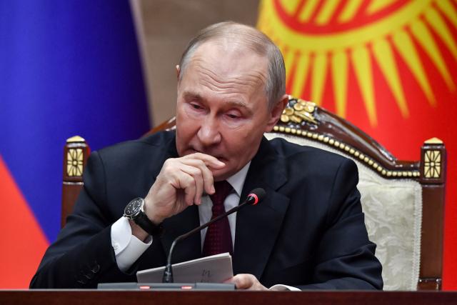 Russian President Vladimir Putin attends a joint media statement with Kyrgyz President following their talks at the Yntymak Ordo (Palace of Unity) presidential residence in Bishkek on November 26, 2025. (Photo by Vyacheslav OSELEDKO / AFP)