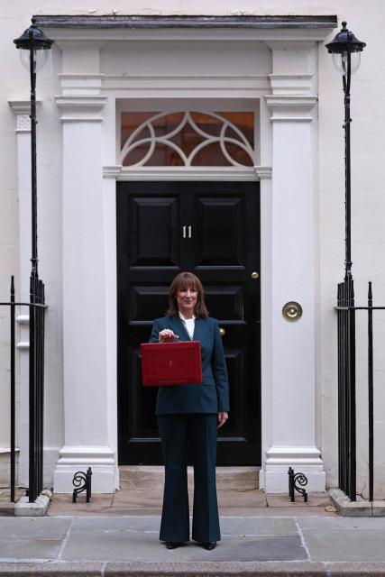 Britain's Chancellor of the Exchequer Rachel Reeves poses with the red Budget Box as she leaves 11 Downing Street, in central London, on November 26, 2025, to present the government's annual Budget to Parliament. (Photo by Adrian Dennis / AFP)