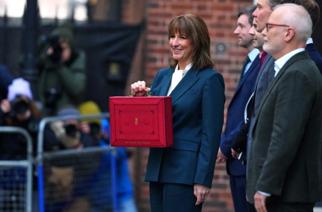 Britain's Chancellor of the Exchequer Rachel Reeves (C) holds the red Budget Box as she poses with members of her Treasury Team, outside 11 Downing Street, in central London, on November 26, 2025, before presenting the government's annual Budget to Parliament. (Photo by Frank Augstein / POOL / AFP)