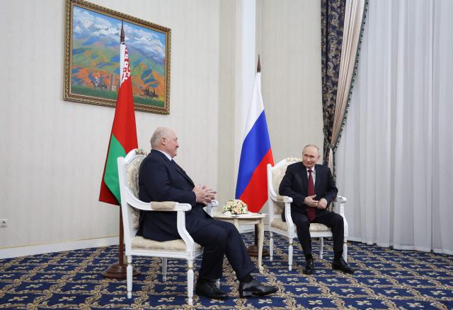 In this pool photograph distributed by the Russian state agency Sputnik, Russia's President Vladimir Putin meets with Belarus' President Alexander Lukashenko in Bishkek on November 26, 2025, on the eve of a meeting of the Collective Security Treaty Organisation (CSTO) Heads of State Council. (Photo by Alexander KAZAKOV / POOL / AFP)