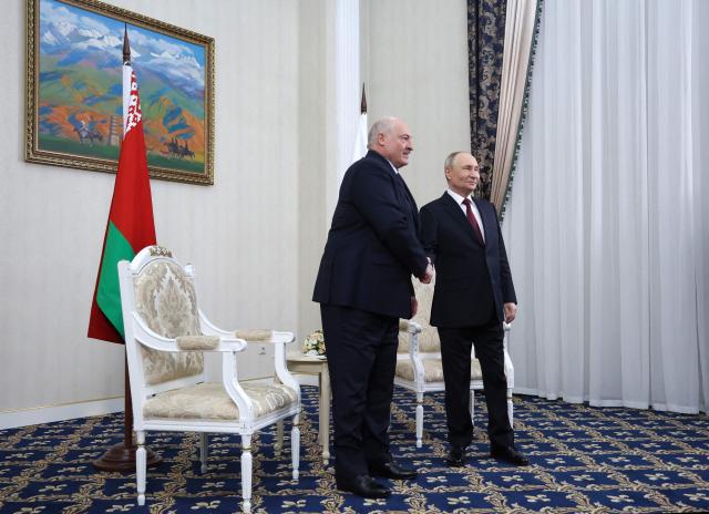 In this pool photograph distributed by the Russian state agency Sputnik, Russia's President Vladimir Putin meets with Belarus' President Alexander Lukashenko in Bishkek on November 26, 2025, on the eve of a meeting of the Collective Security Treaty Organisation (CSTO) Heads of State Council. (Photo by Alexander KAZAKOV / POOL / AFP)