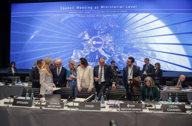German Minister for Research, Technology and Aerospace Dorothee Baer (C-L) and ERSA General Director Josef Aschbacher (C-R) arrive to chair the European Space Agency (ESA) ministerial meeting at the Congress Centrum in Bremen, northern Germany, on November 26, 2025. Ministers from the 23 member states of the European Space Agency (ESA) meet in the Hanseatic city for two days to discuss the strategic direction of European spaceflight. (Photo by FOCKE STRANGMANN / AFP)