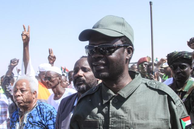 Darfur Regional Governor and leader of the Sudan Liberation Movement (SLM), Minni Arko Minnawi, is greeted as he arrives at the Al-Afad camp for displaced people in the town of Al-Dabba, northern Sudan, on November 26, 2025. Since its outbreak in April 2023, the war between Sudan's army and the paramilitary Rapid Support Forces (RSF) has killed tens of thousands of people and displaced nearly 12 million. At the end of October, the paramilitary group seized control El-Fasher, the conclusion of a bitter 18-month siege for the strategic hub in western Sudan's Darfur region and marked by reports of mass killings and sexual violence. (Photo by Ebrahim Hamid / AFP)