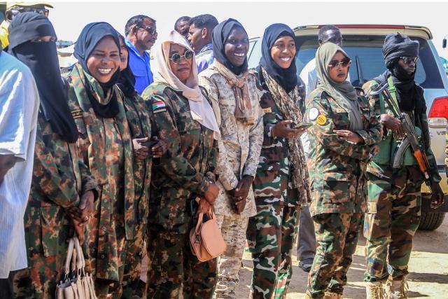 Supporters of Darfur Regional Governor and leader of the Sudan Liberation Movement (SLM), Minni Arko Minnawi, wait to greet him as he arrives at the Al-Afad camp for displaced people in the town of Al-Dabba, northern Sudan, on November 26, 2025. Since its outbreak in April 2023, the war between Sudan's army and the paramilitary Rapid Support Forces (RSF) has killed tens of thousands of people and displaced nearly 12 million. At the end of October, the paramilitary group seized control El-Fasher, the conclusion of a bitter 18-month siege for the strategic hub in western Sudan's Darfur region and marked by reports of mass killings and sexual violence. (Photo by Ebrahim Hamid / AFP)